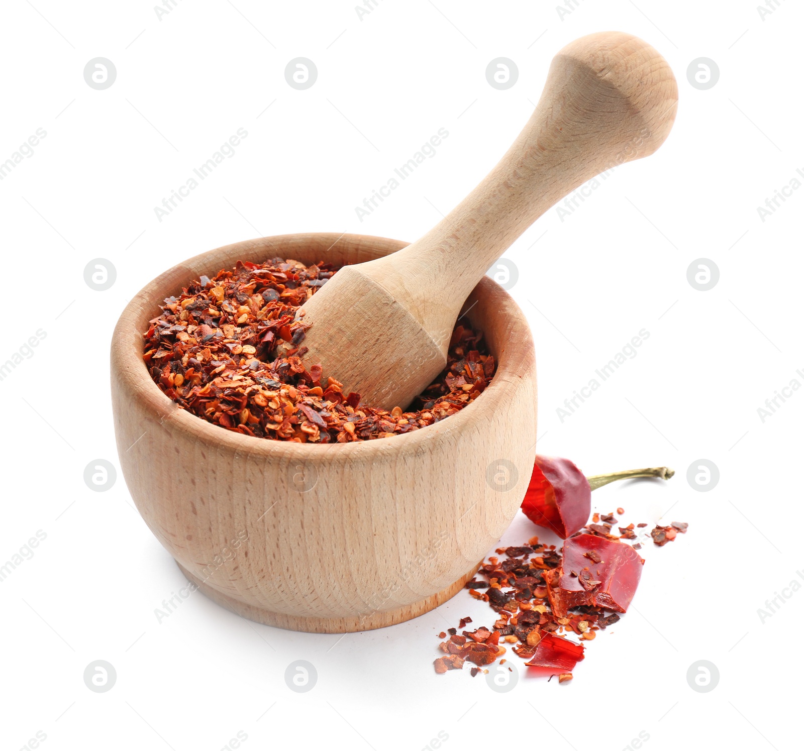 Photo of Wooden mortar with chili pepper flakes on white background