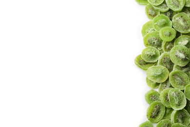 Photo of Slices of kiwi on white background, top view with space for text. Dried fruit as healthy food