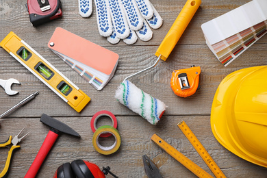 Flat lay composition with different construction tools on wooden background