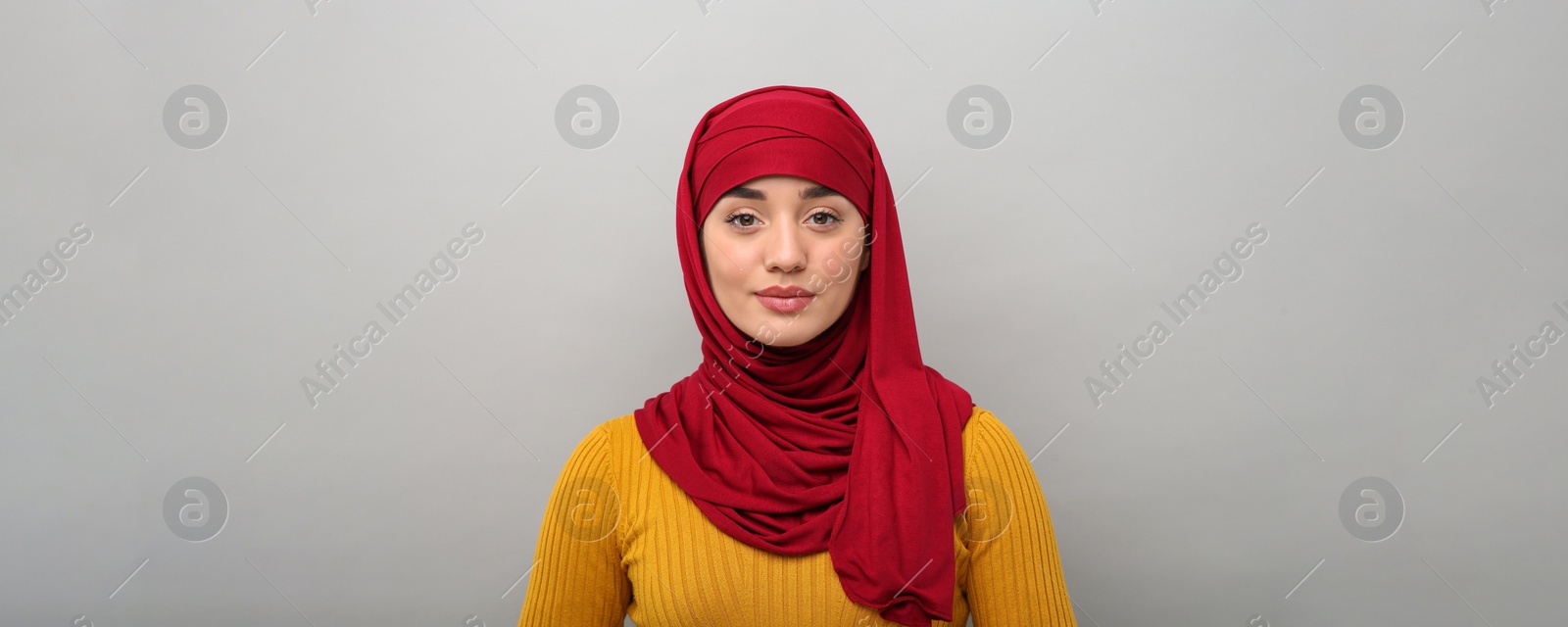 Image of Portrait of Muslim woman in hijab on light grey background. Banner design