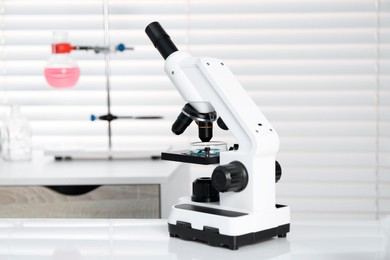 Photo of Laboratory analysis. Modern medical microscope on white table indoors