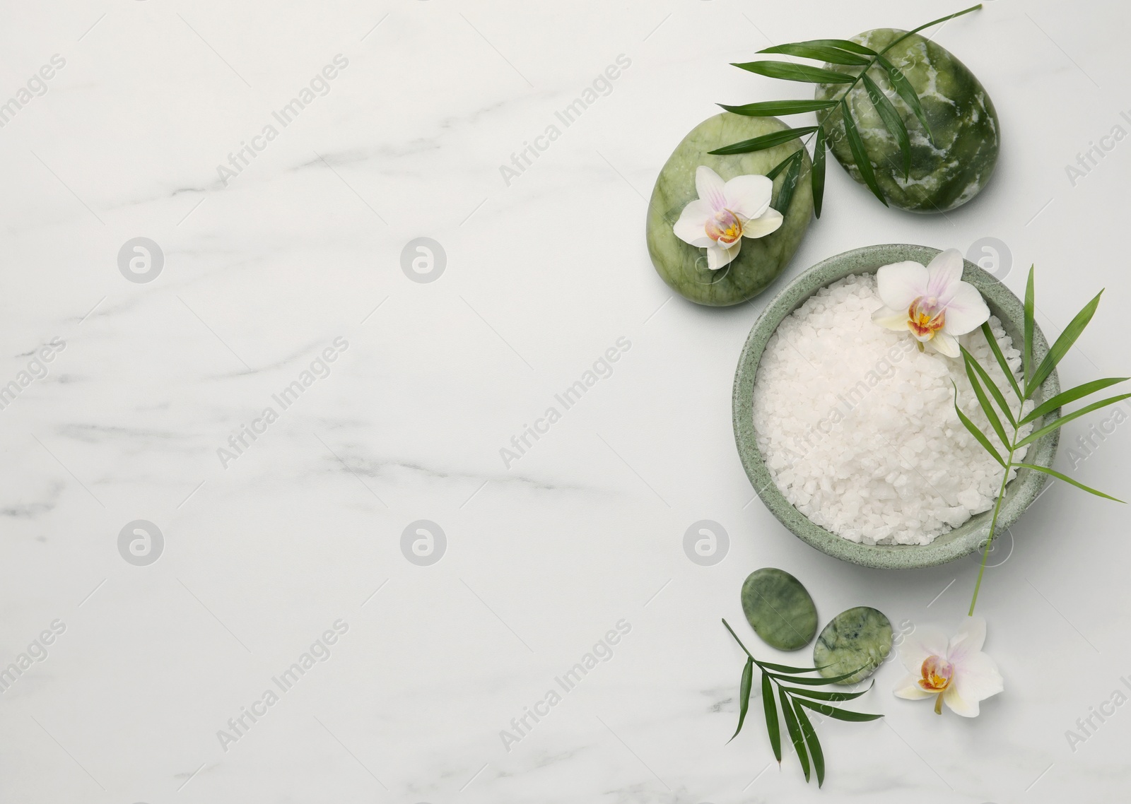 Photo of Flat lay composition with spa products and flowers on white marble table. Space for text