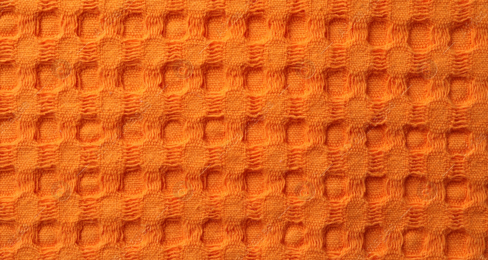 Photo of Texture of orange knitted fabric as background, top view