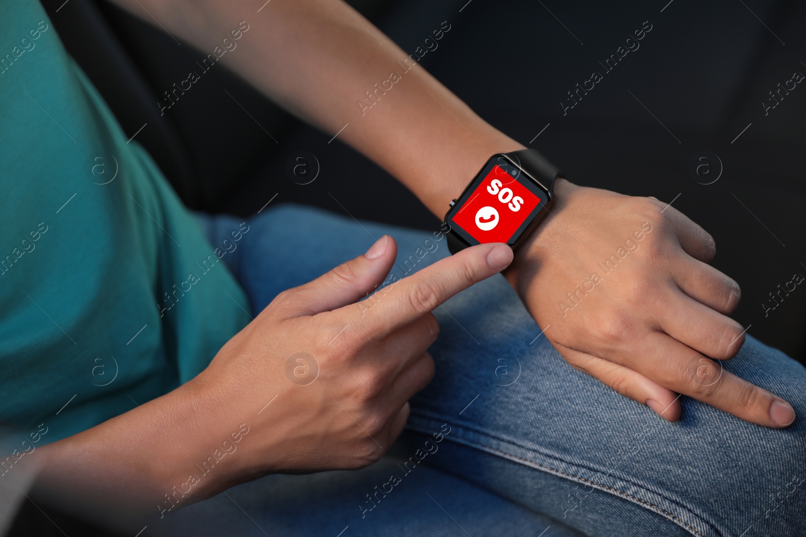 Image of Woman using SOS function on smartwatch in car, closeup