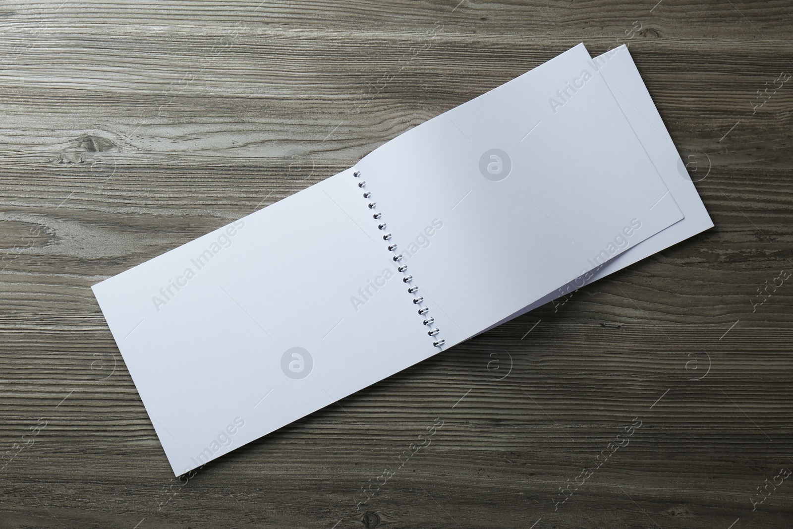 Photo of Blank paper brochure on wooden table, top view. Mockup for design