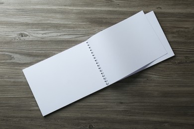 Photo of Blank paper brochure on wooden table, top view. Mockup for design