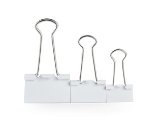 Photo of Different binder clips on white background. Stationery item