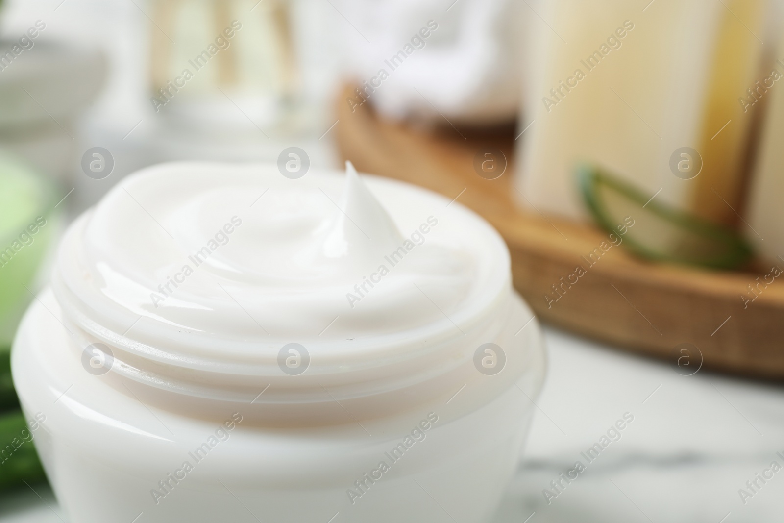 Photo of Open jar of aloe cream on table, closeup. Organic cosmetics