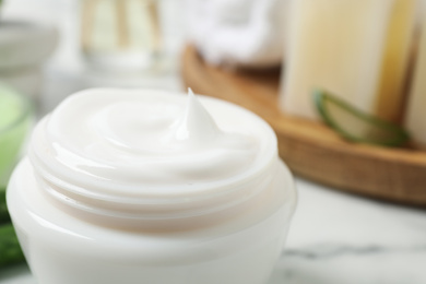 Open jar of aloe cream on table, closeup. Organic cosmetics