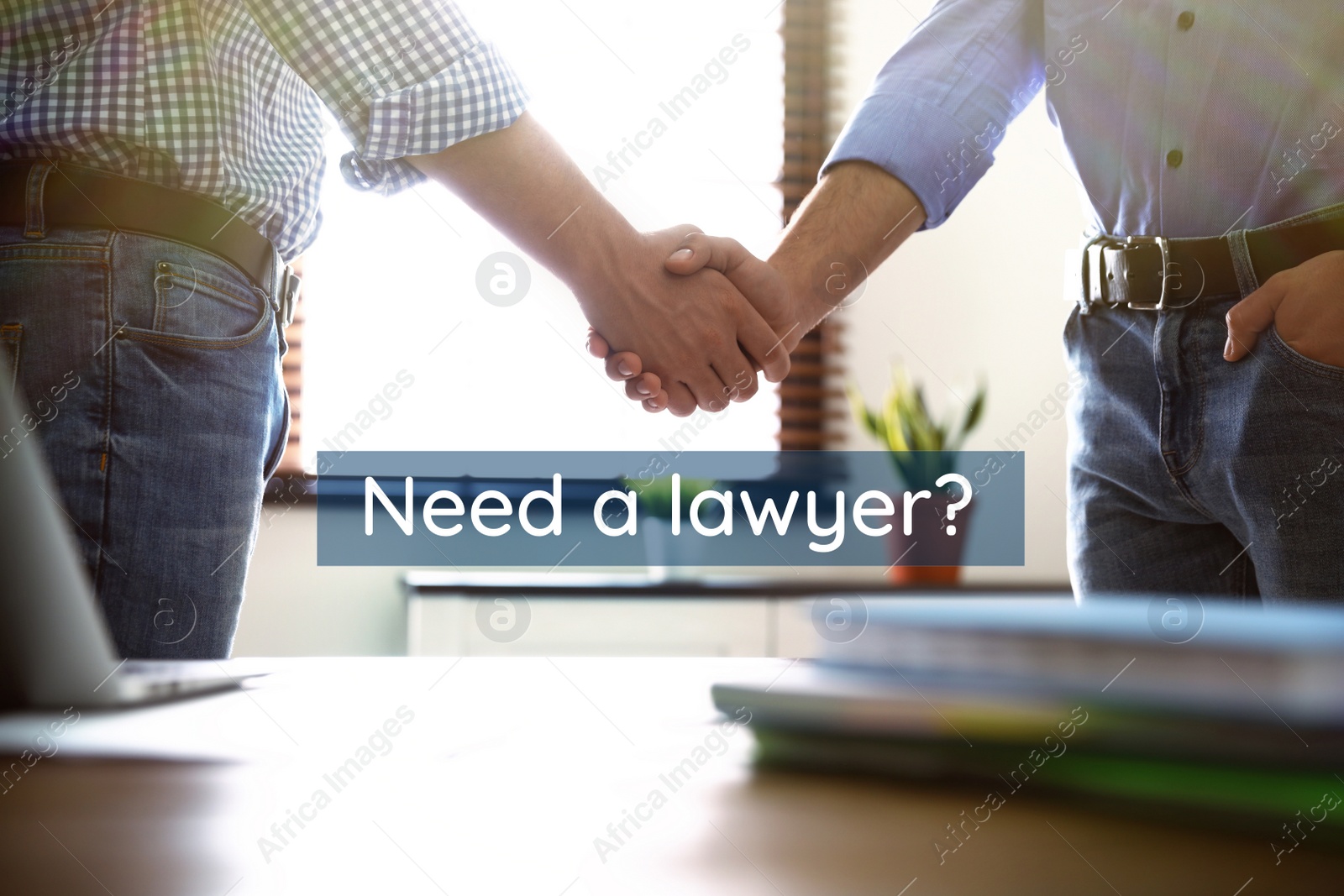 Image of Business partners shaking hands at table in office, closeup. Need a lawyer?