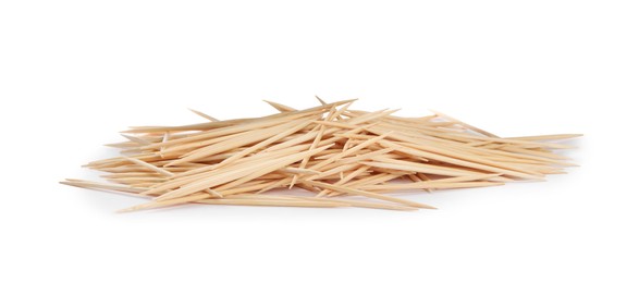 Heap of wooden toothpicks on white background