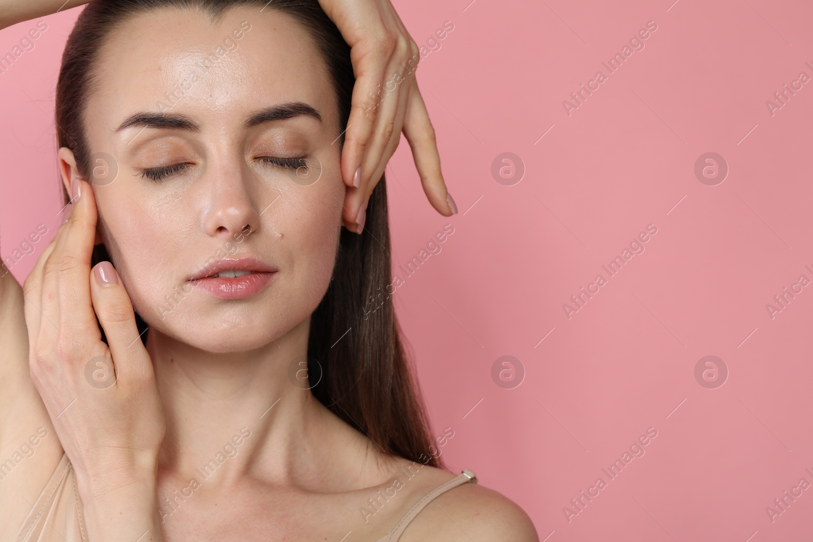 Photo of Portrait of beautiful young woman on pink background. Space for text