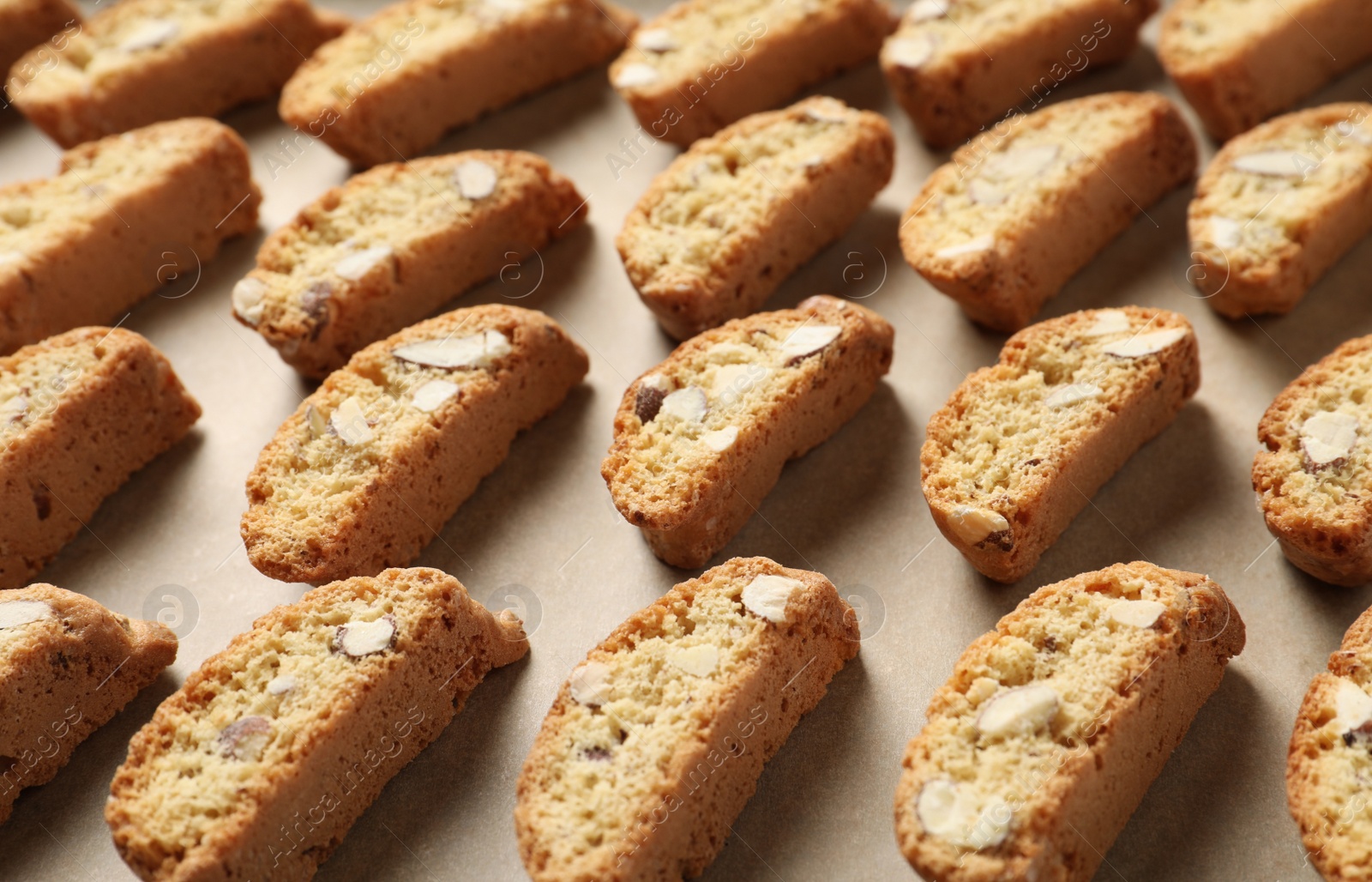 Photo of Traditional Italian almond biscuits (Cantucci) on parchment paper, closeup