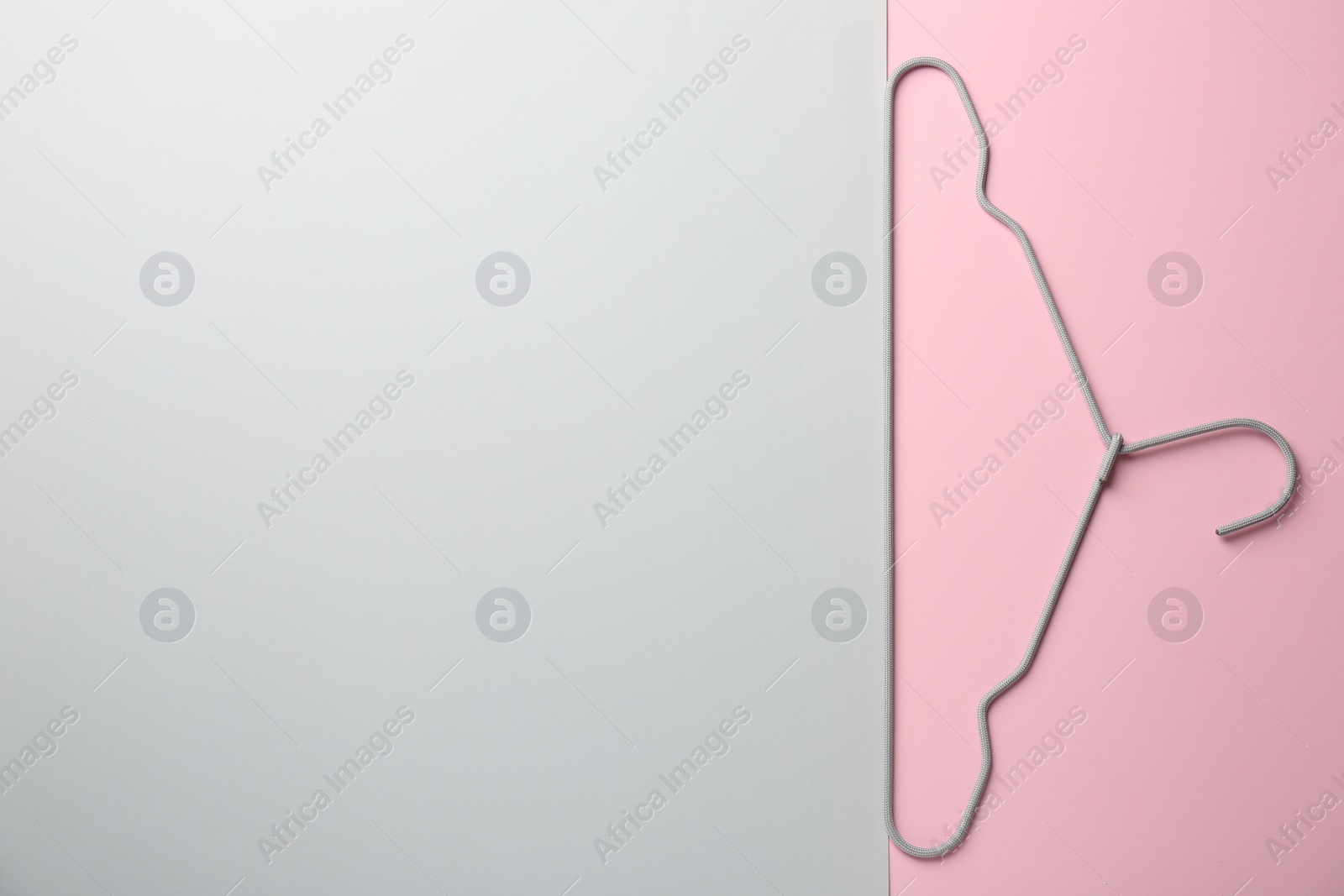 Photo of Hanger on color background, top view. Space for text
