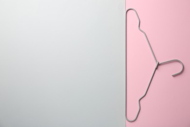 Photo of Hanger on color background, top view. Space for text