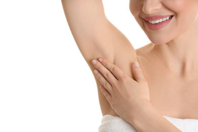 Photo of Young beautiful woman showing armpit with smooth clean skin on white background, closeup