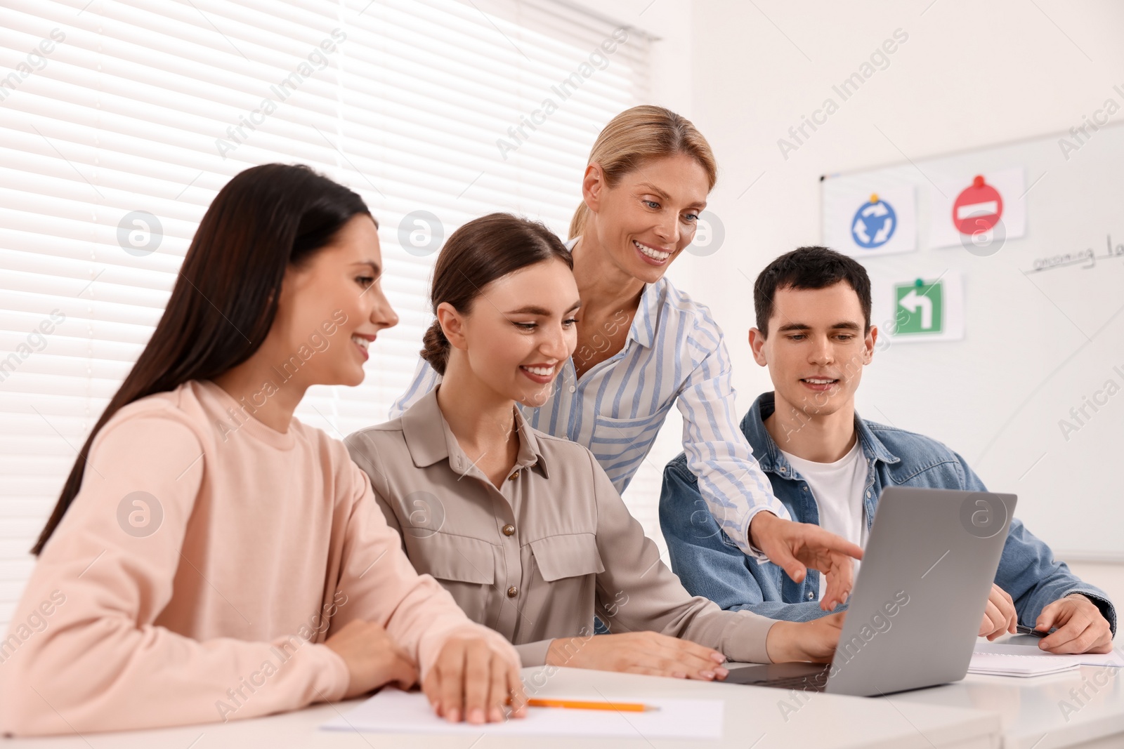 Photo of Happy teacher giving lesson in driving school