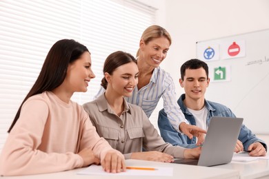 Photo of Happy teacher giving lesson in driving school