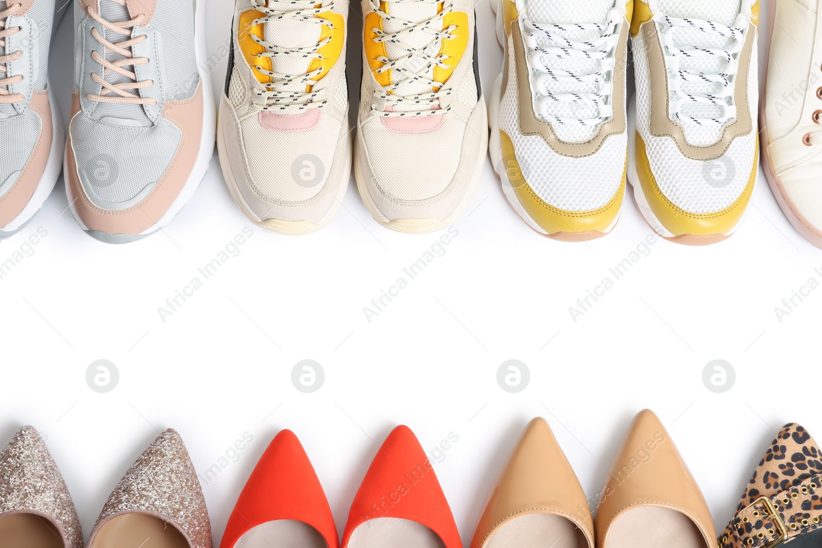 Photo of Frame of different shoes on white background, top view with space for text