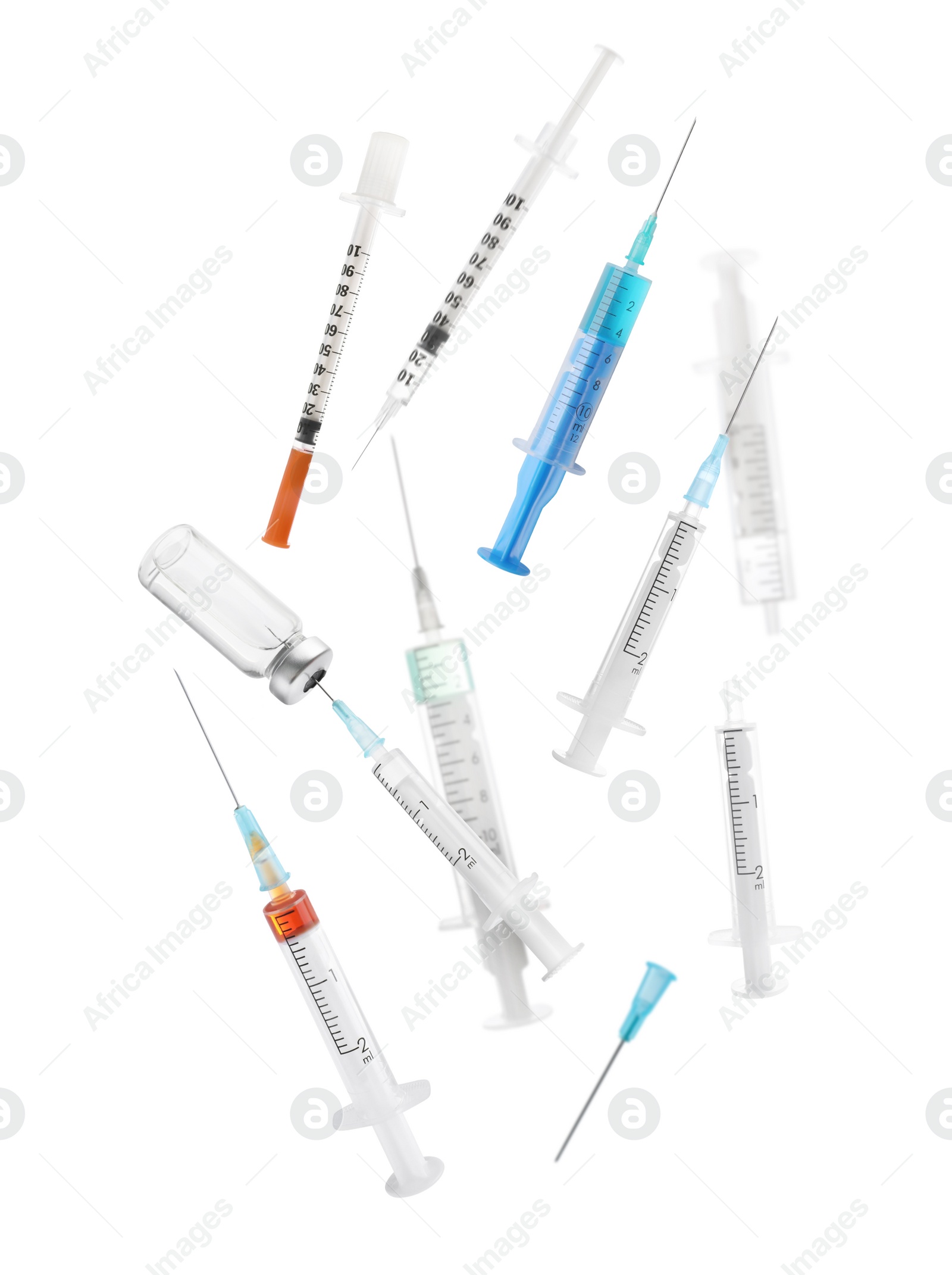 Image of Different disposable syringes falling on white background. Medical equipment