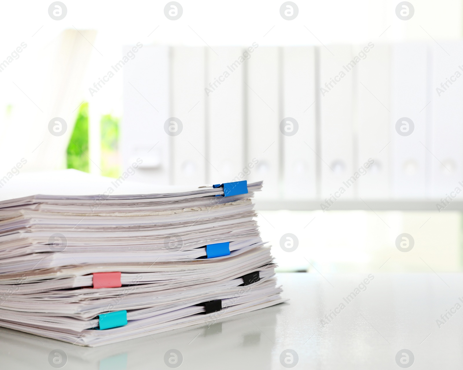 Photo of Stack of documents with paper clips on office desk. Space for text