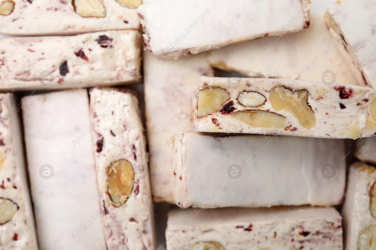 Photo of Pieces of delicious nougat as background, top view