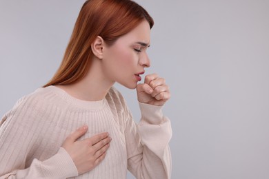 Photo of Woman coughing on light grey background, space for text. Cold symptoms