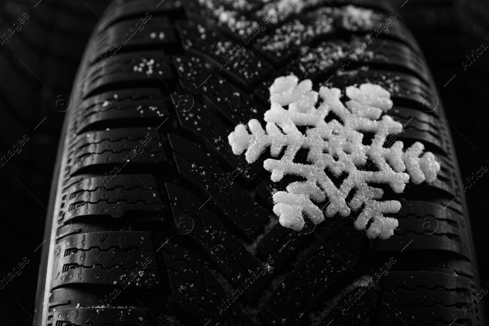 Photo of Snowy new winter tires as background, closeup