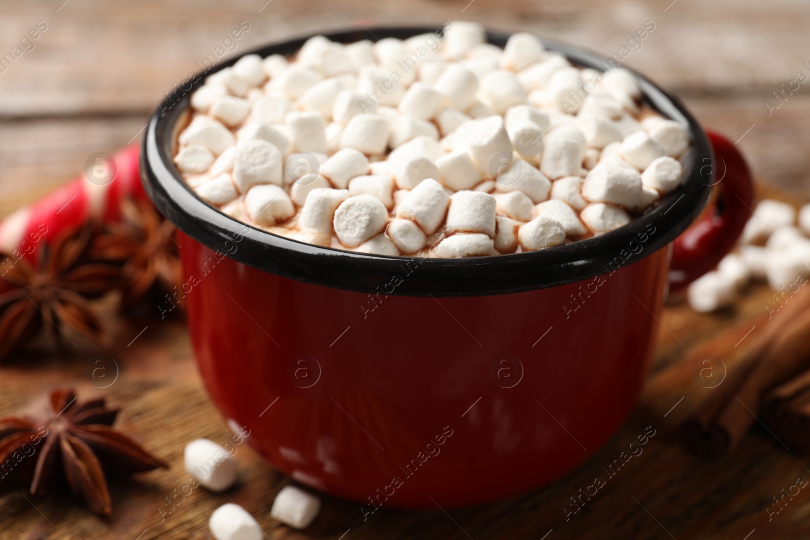 Photo of Tasty hot chocolate with marshmallows on wooden table, closeup