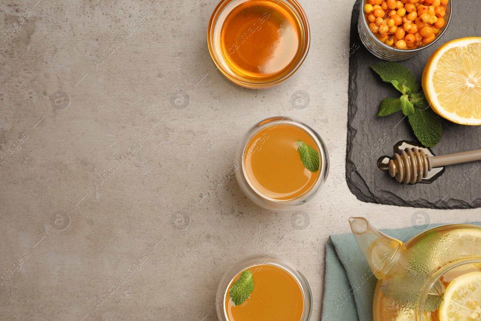 Photo of Flat lay composition with immunity boosting drink and ingredients on grey table, space for text