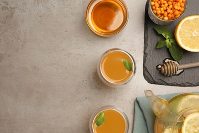 Photo of Flat lay composition with immunity boosting drink and ingredients on grey table, space for text