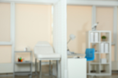 Photo of Blurred view of doctor's office interior with couch