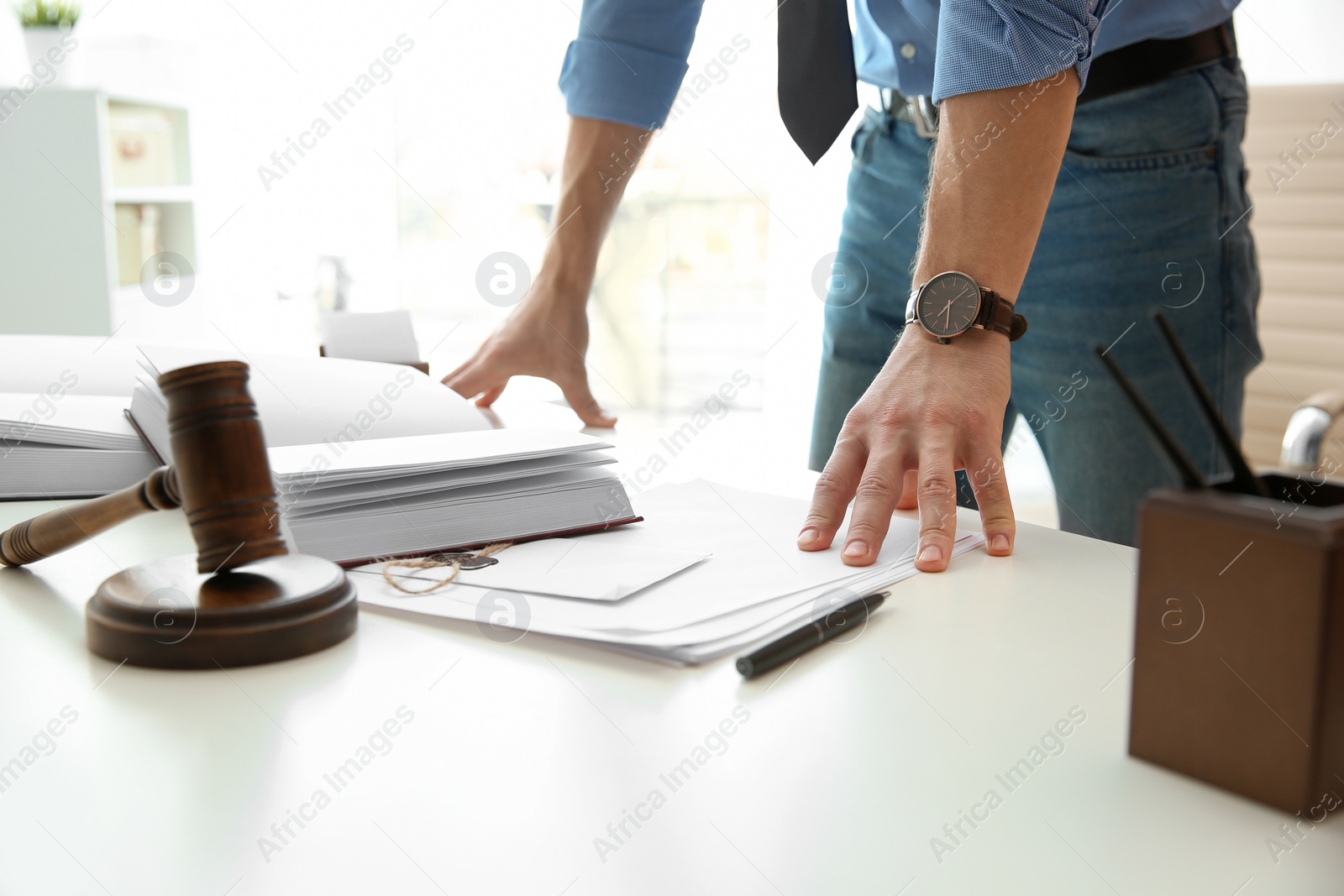 Photo of Notary working with papers and judge gavel on table. Law and justice concept