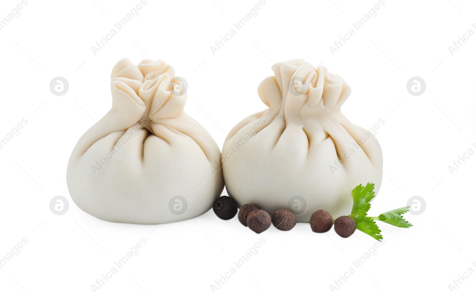 Photo of Uncooked khinkali (dumplings) and spices isolated on white. Georgian cuisine