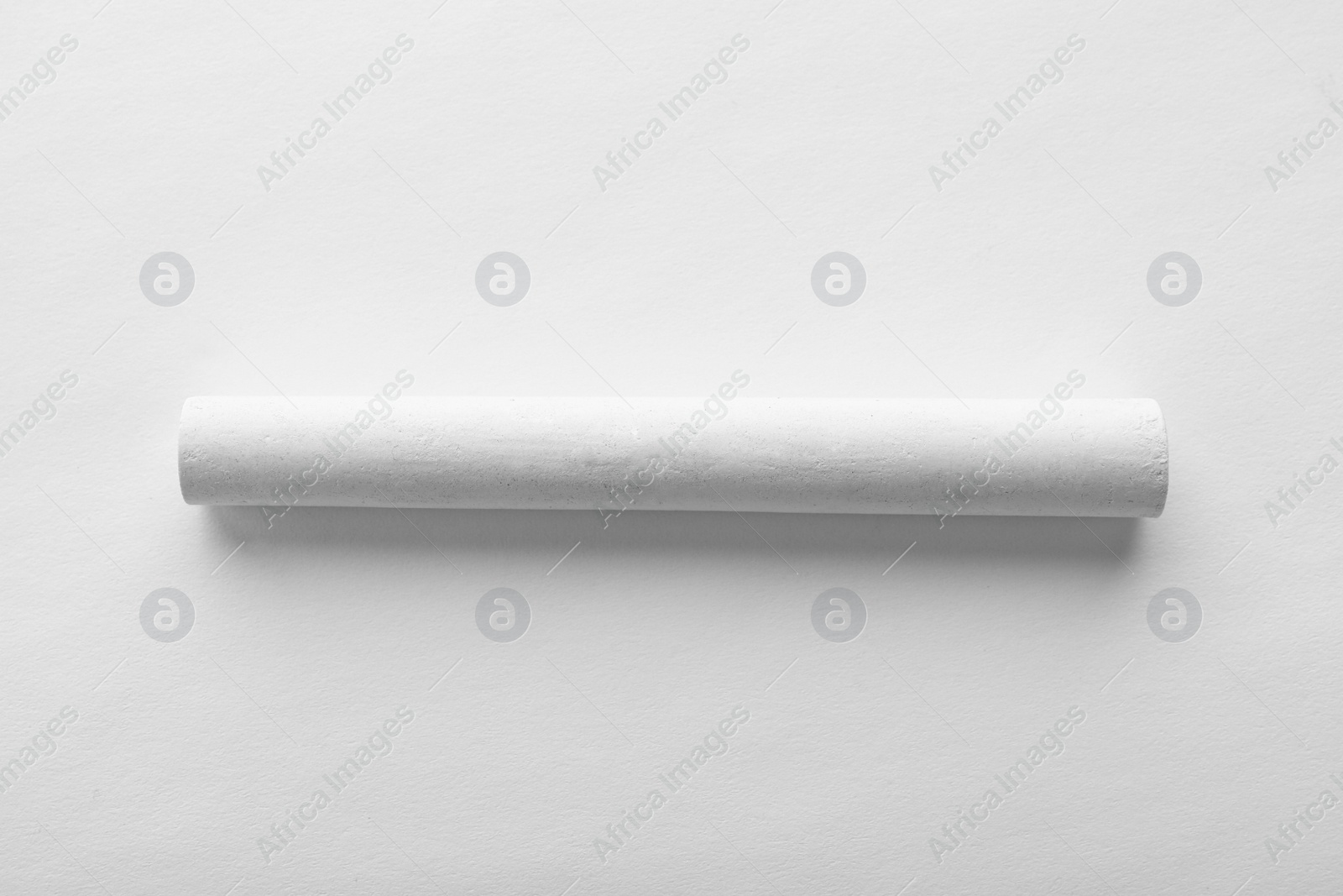 Photo of Piece of chalk isolated on white, top view