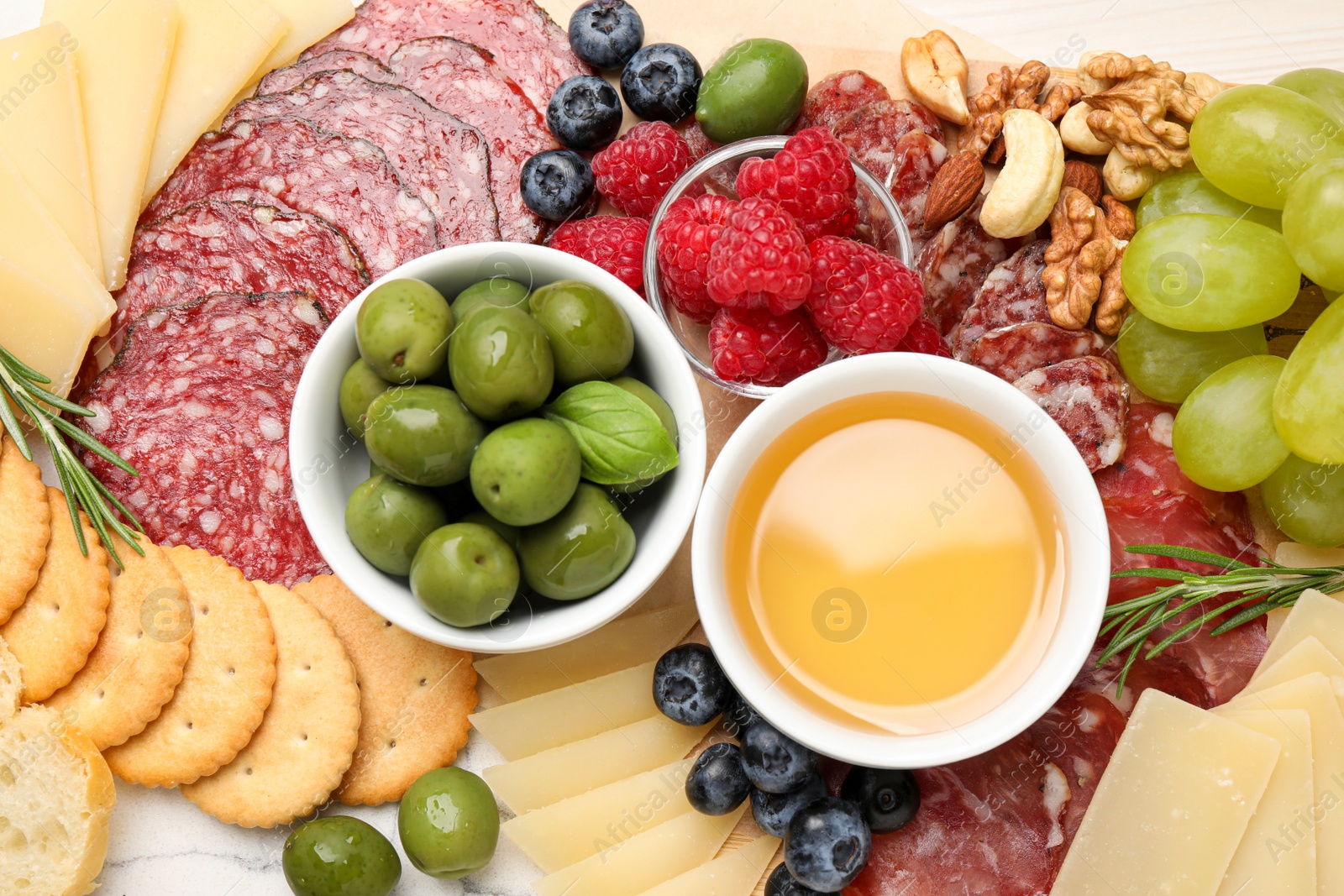 Photo of Snack set with delicious Parmesan cheese on board, top view