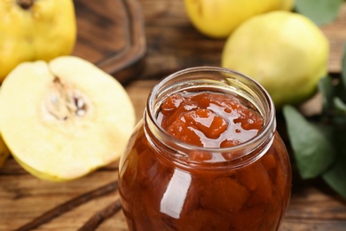 Delicious quince jam in jar on table, closeup