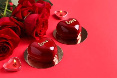 Photo of St. Valentine's Day. Delicious heart shaped cakes and roses on red background