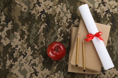 Flat lay composition with books and diploma on camouflage background, space for text. Military education concept