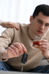 Photo of Woman stopping man from drunk driving, closeup. Don't drink and drive concept