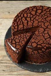 Delicious chocolate truffle cake on wooden table