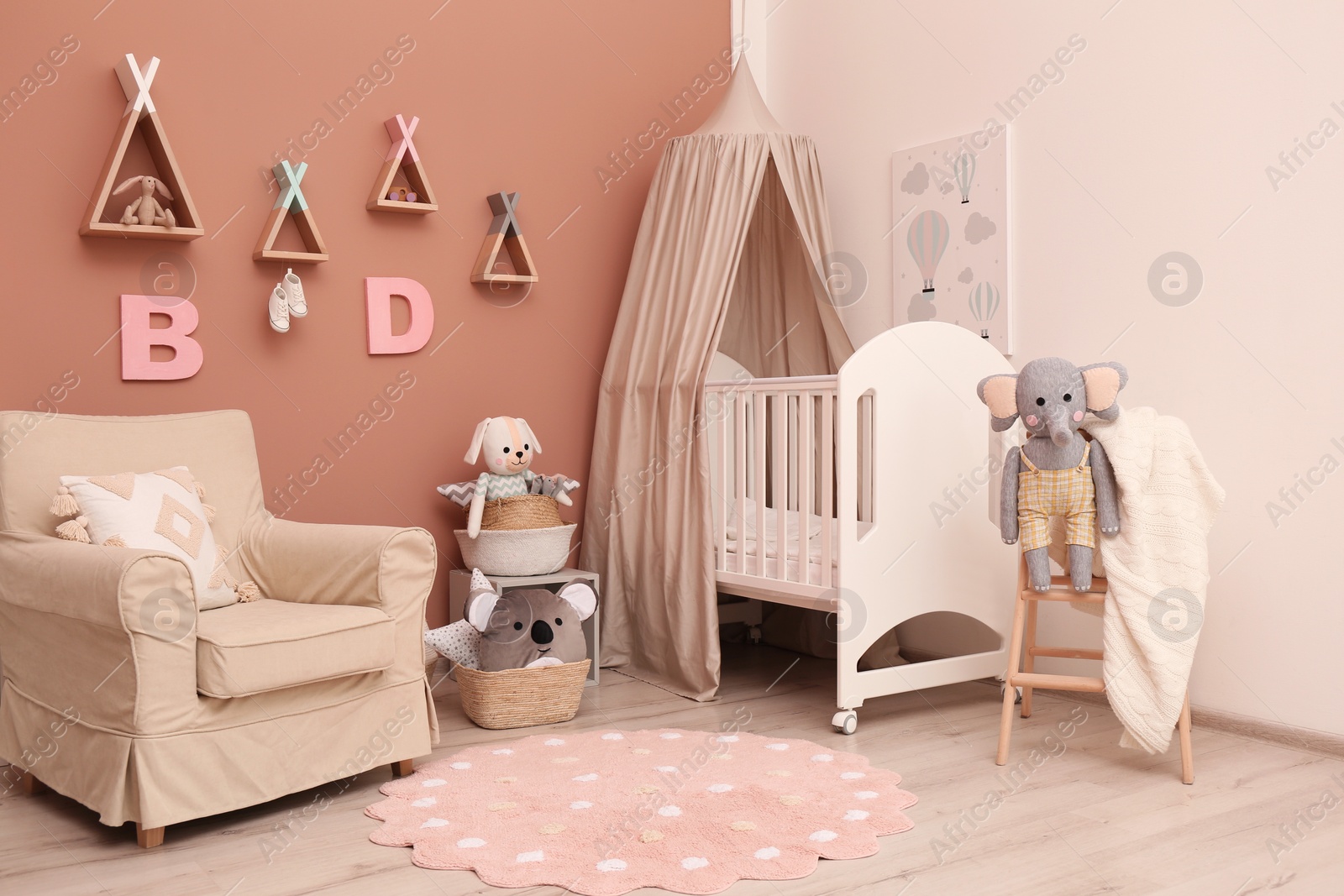 Photo of Baby room interior with stylish furniture and comfortable crib