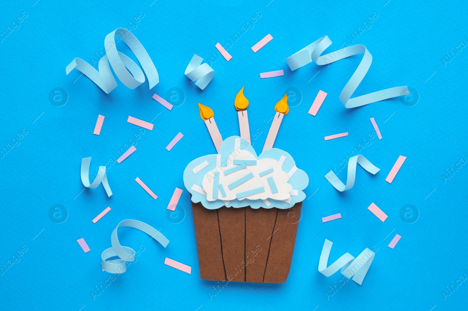 Photo of Birthday party. Paper cupcake and confetti on light blue background, flat lay