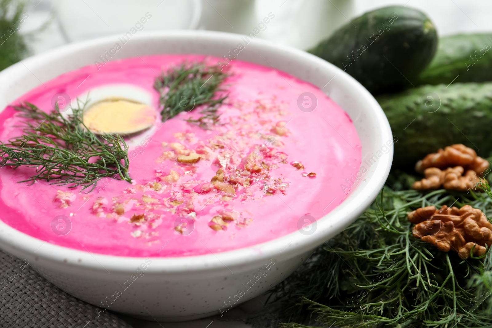 Photo of Delicious cold summer beet soup in bowl, closeup