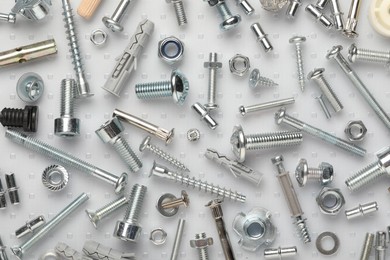 Many different fasteners on plastic surface, flat lay