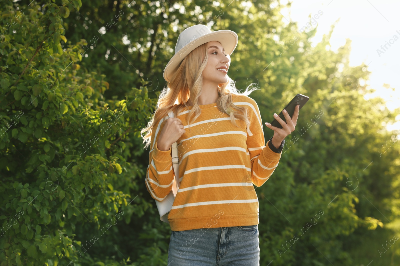 Photo of Portrait of happy young woman in park on spring day