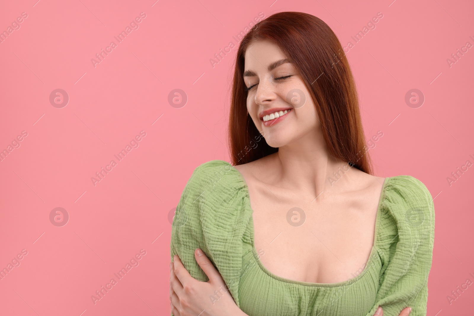 Photo of Portrait of smiling woman with freckles on pink background. Space for text