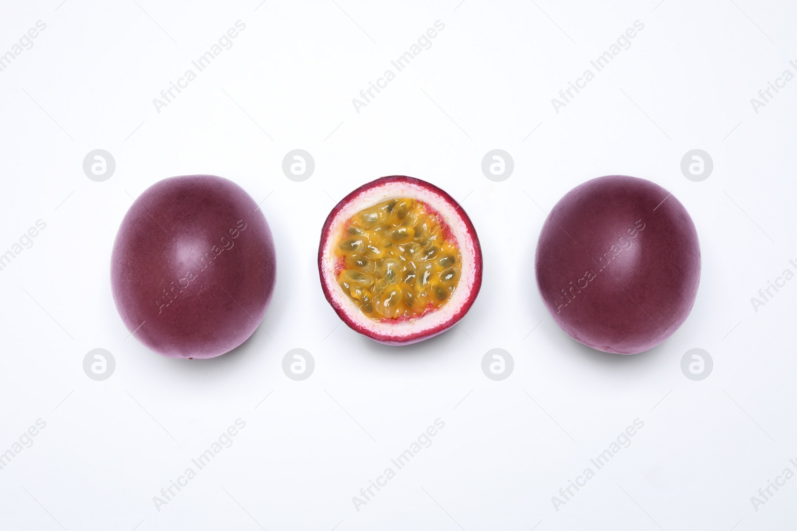 Photo of Fresh ripe passion fruits (maracuyas) on white background, flat lay