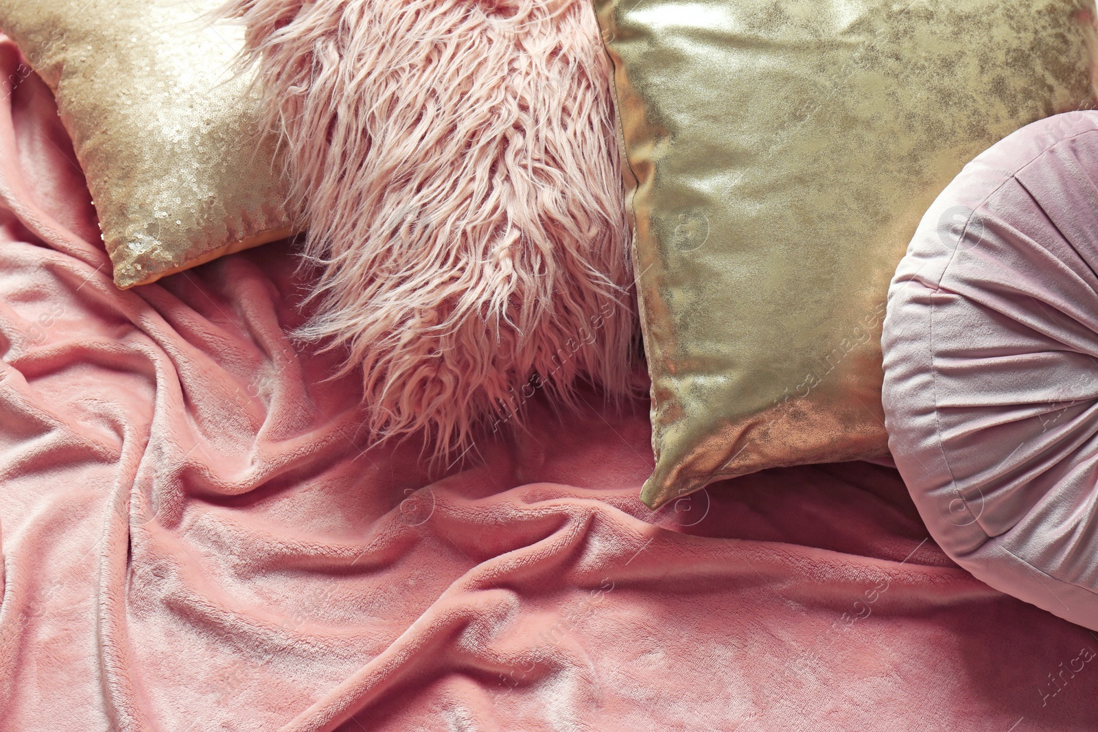 Photo of Stylish pillows and plaid on bed, above view