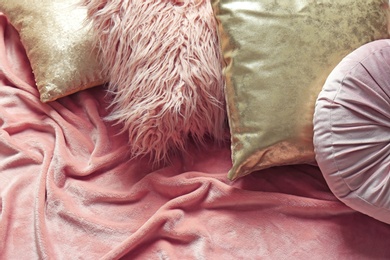 Photo of Stylish pillows and plaid on bed, above view